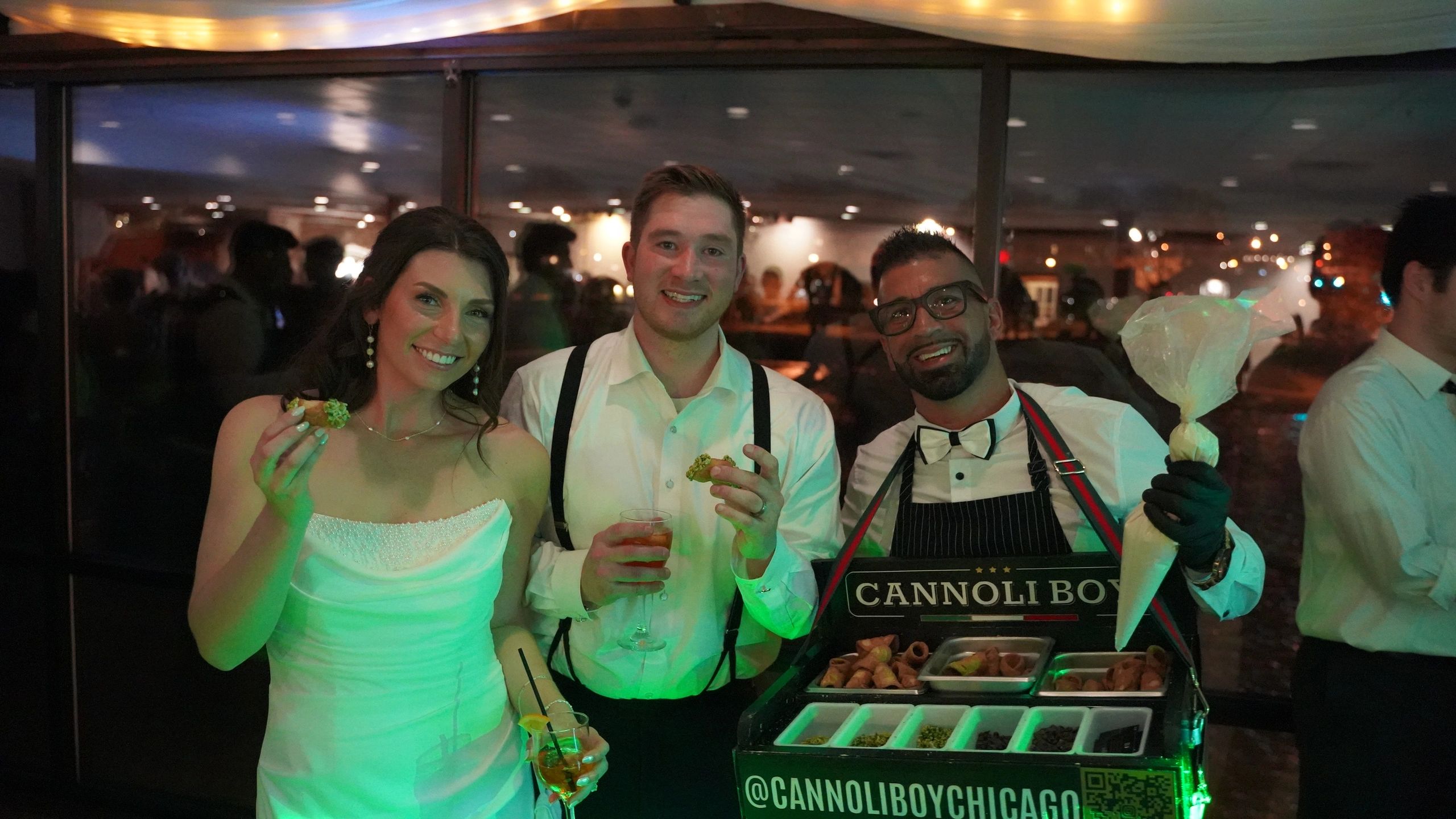 Cannoli Boy food cart at event with guests and city skyline